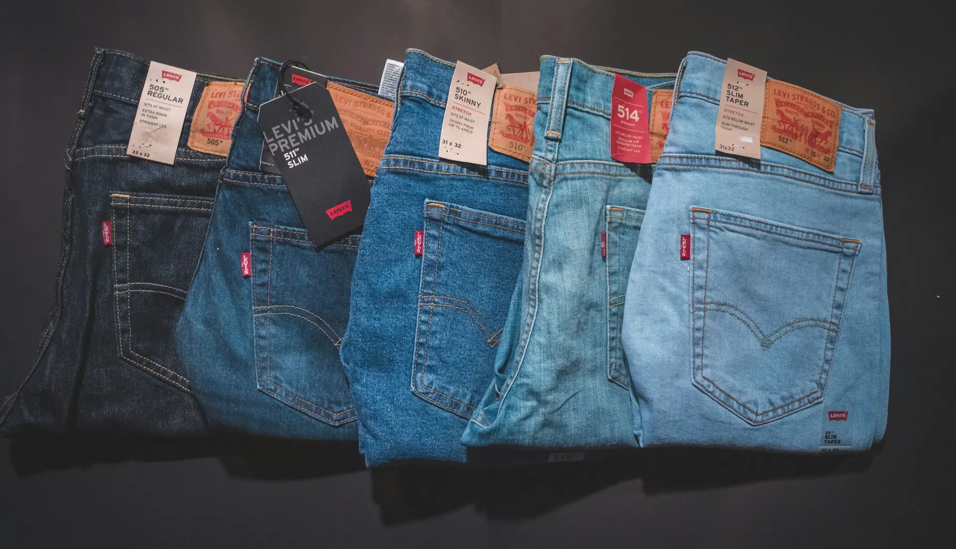 blue denim jeans on black surface